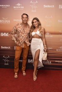 a man and woman posing on a red carpet