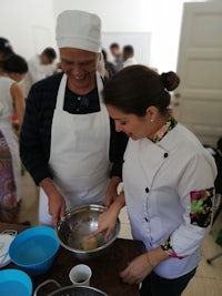 a man and woman are preparing food in a kitchen