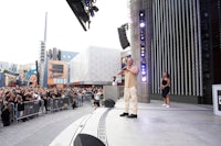 a man standing on a stage in front of a crowd