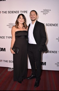 a man and woman posing for a photo on the red carpet