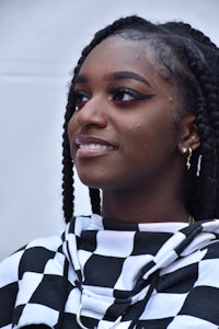 a young woman wearing a black and white checkered shirt