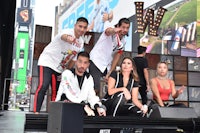 a group of people posing on a stage in front of a crowd