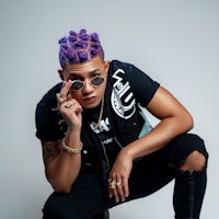 a man with purple hair posing for a photo