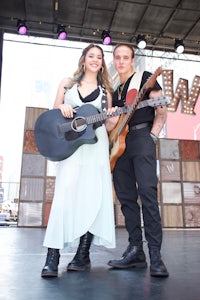 a man and a woman holding guitars