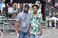 two men posing for a photo in times square