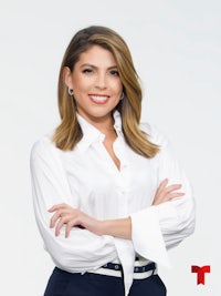 a woman in a white shirt and black pants is posing for a photo