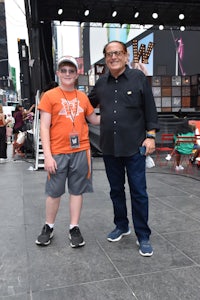 a man and a boy standing on a stage