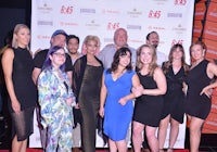 a group of people posing for a picture on a red carpet