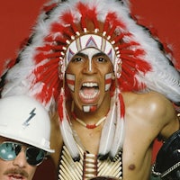 two men in indian headdress posing for a photo