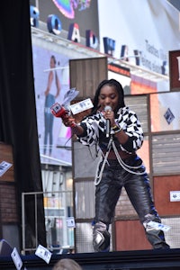 a woman is holding a microphone