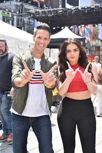 a man and a woman posing for a photo in times square