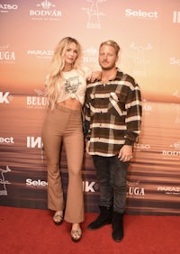 a man and woman posing on a red carpet