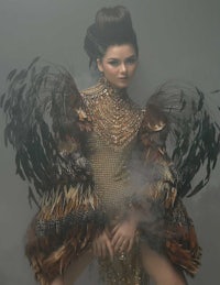 a woman in a feathered dress posing for a photo