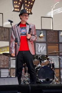 a man standing on a stage holding a microphone