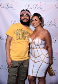 a man and woman posing for a photo on the red carpet