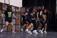 a group of young people dancing on a stage