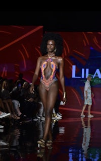 a woman in a bikini on the runway