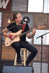 a man playing an acoustic guitar