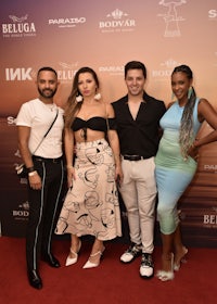 a group of people posing on a red carpet